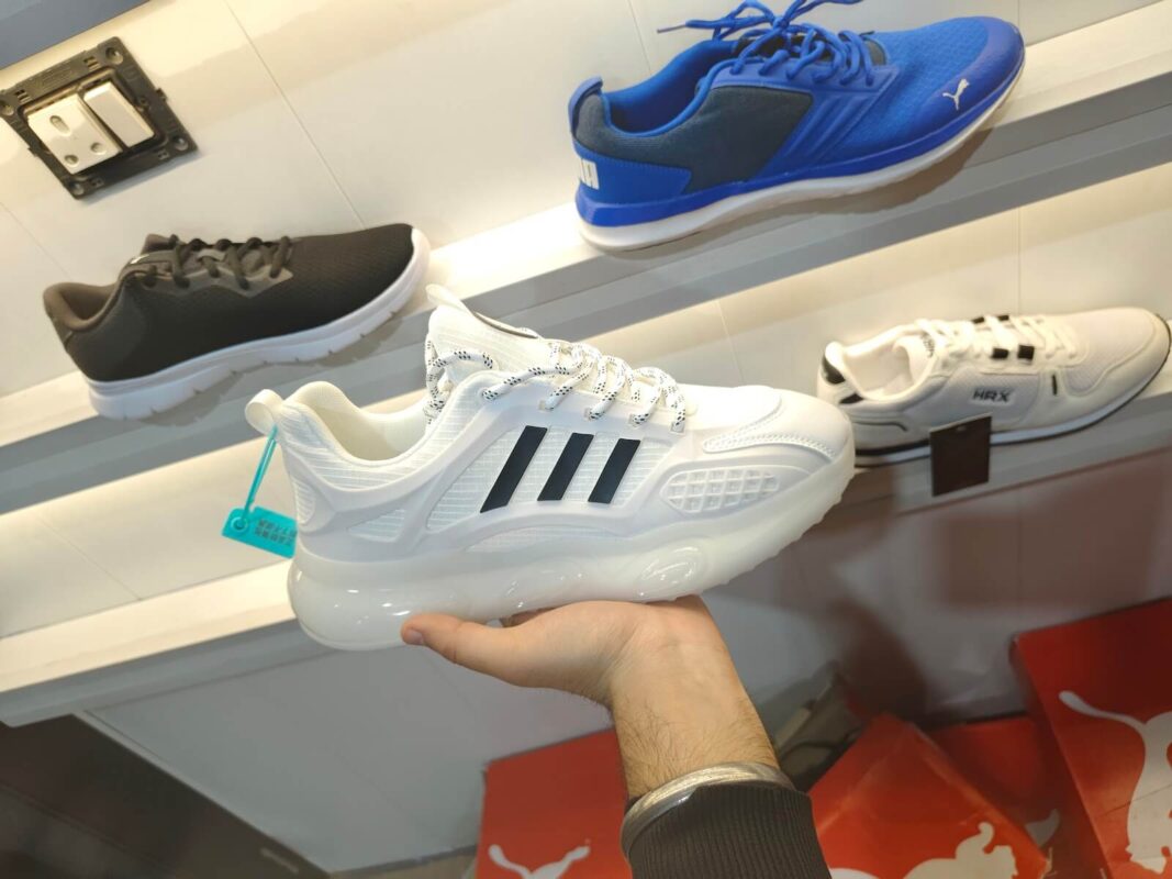 white adidas imported shoe in my hand