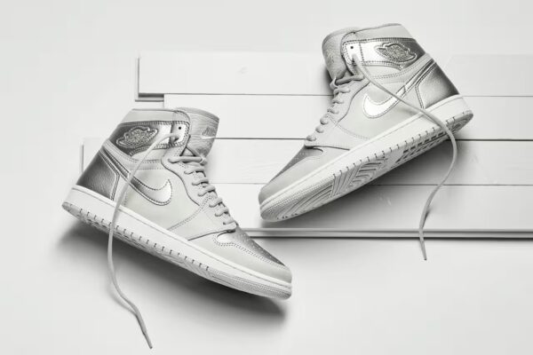 pair of air jordan high co.jp metallic silver in a silver background