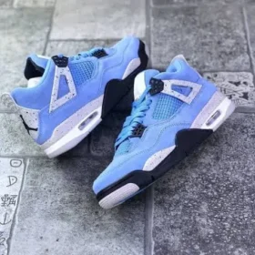 pair of jordan 4 university blue on road
