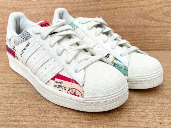 pair of adidas superstar ivory top front side view