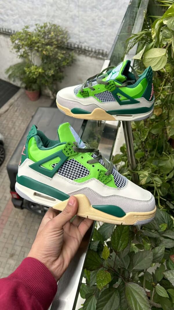 jordan 4 green in hand