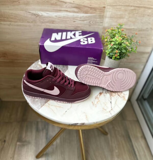 sb dunk burgundy on table with box